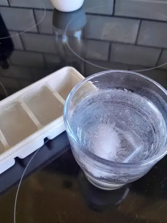 Ice cube scum with silicone ice cube tray in background