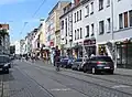 Something like shared lanes (with bike marks between the rails), though that term does not exist in Germany