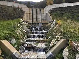 check_dam=slit, check_dam:screen=grill, screen:material=metal (with smaller solid check dams in the foreground)