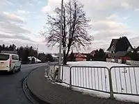 Road in Poland with a barely visible road reference marker, not intended to be a reassurance used for navigation. Tagged with unsigned_ref=*