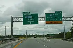 Left: junction:ref=1B destination:ref=I 65 South destination:street:to=Western Kentucky Parkway destination=Nashville;Paducah Right: junction:ref=1A destination:ref=I 65 North destination=Elizabethtown;Louisville