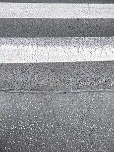 No kerb on footway leaving crossing island onto road with a marked crossing