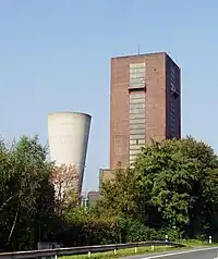 or - mineshaft_type=winding;air and headframe=no (because it is not visible) and building=yes