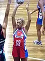 Erin Bell from the New South Wales (Australia) Swifts (red) prepares to shoot for a goal against the