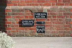 flood_mark=plaque Flood marks on the wall of a lock keeper's cottage