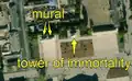 4/7 City centre of a large city with two murals (tourism=artwork and artwork_type=mural), recognisable because they have the shape of a wall that leaves a shadow, with nothing around it, and a tower of immortality (historic=memorial and memorial=immortality_tower), with its shadow cast on the ground, (Maxar satellite imagery). One of the murals was added after 2011, the year Kim Jong-il died.