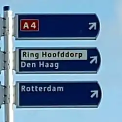The older/traditional signposting style for ring routes renders Ring Hoofddorp as a local destination, separately from any road number (here A 4). Add name=Ring Hoofddorp and noref=yes to the ring route relation.