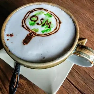 Cappuccino cup with OSM logo variation painted. During a local mapper meeting in Chang Mai on 11th October 2018.