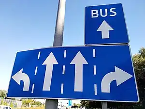 A regulatory sign posted to the side of the road that indicates the use of each lane