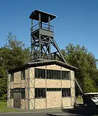 or - headframe=yes and disused=yes (there are no cables anymore) and building=yes