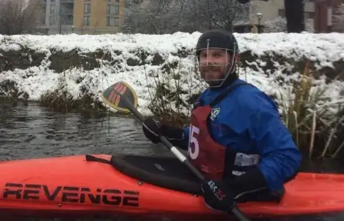 Kayaker wearing pogies