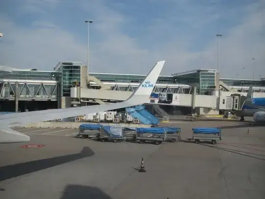 Schiphol airport out of a plane, with wing tip and gates