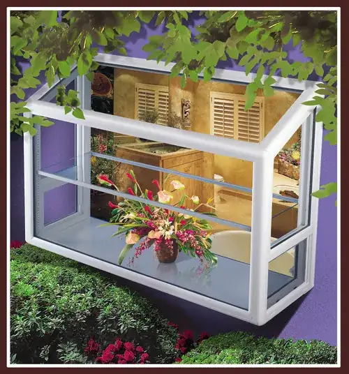 A greenhouse on a window with flowers arranged.