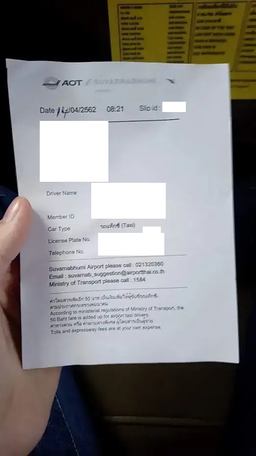 Slip of paper with contact information (PII blanked out)