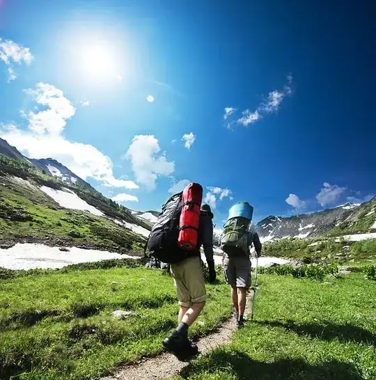 image of people carrying tents strapped on the bag