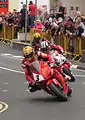 2013 Isle of Man TT&nbsp;Superbike Race Lap 4&nbsp;– John McGuinness (3), Michael Dunlop (6) & Cameron Donald (2) Parliament Square, Ramsey 2 June 2013.