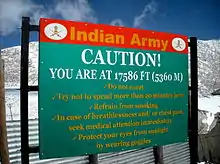 Sign displays "Caution! You are at 17586&nbsp;ft (5360&nbsp;m)"