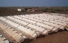 The condenser at Satapar in India consists of eleven ridges. The ridges are trapezoidal in section (top 50&nbsp;cm, base 200&nbsp;cm, two sides sloping 30-degree from horizontal, height 100&nbsp;cm) and each is 20 m long. The ridges are built over gently sloping ground. All the ridges drain into a common pipe at the lower and leading to storage below ground. Water for use is withdrawn by a hand pump. The system was commissioned in early April 2007. Total cost of the installation was Rs 117,000.