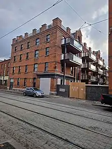 Re-developed social housing block with new brick work, windows, and balconies.