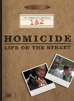 A DVD box-set cover with a background resembling a brown file folder, including a metal clip at the top. The words "Homicide: Life on the Street" are printed in the middle of the cover, with the words "The Complete Seasons 1&nbsp;&&nbsp;2" above it. Underneath the words are two images resembling photographs, one with a man wearing a suit jacket looking straight forward and pointing with his index finger, and the other of two men wearing dress shirts leaning forward and looking sideways.