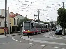 A train on 15th Avenue turning onto Ulloa Street, 2017