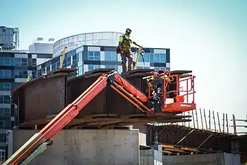 A worker atop a partially complete bridge