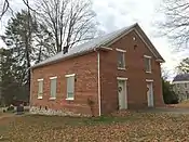 Front and side of the church; the side has three windows.