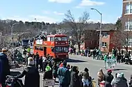 Parade floats, including the Peter Pan parade bus, move toward downtown on Beech Street