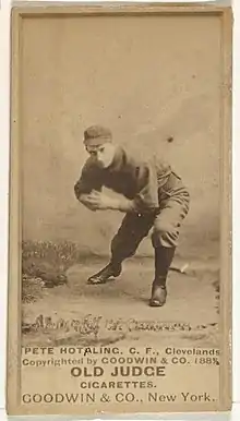 Man in baseball uniform bending down