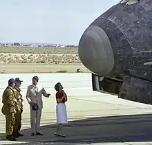 "President Ronald Reagan chats with NASA astronauts Henry Hartsfield and Thomas Mattingly on the runway as first lady Nancy Reagan scans the nose of Space Shuttle Columbia following its Independence Day landing at Edwards Air Force Base on July&nbsp;4, 1982."