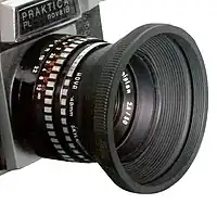Praktica camera – lens with a conical collapsible rubber lens hood (50&nbsp;mm f/2.8).