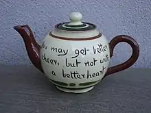 A round earthenware teapot, inscribed 'You may get better cheer, but not with a better heart'