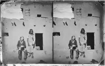 The man seated left is a Zuni with albinism. The Zuni people and other indigenous tribes of the American Southwest have a very high incidence of albinism..mw-parser-output cite.citation{font-style:inherit;word-wrap:break-word}.mw-parser-output .citation q{quotes:"\"""\"""'""'"}.mw-parser-output .citation:target{background-color:rgba(0,127,255,0.133)}.mw-parser-output .id-lock-free a,.mw-parser-output .citation .cs1-lock-free a{background:url("//upload.wikimedia.org/wikipedia/commons/6/65/Lock-green.svg")right 0.1em center/9px no-repeat}.mw-parser-output .id-lock-limited a,.mw-parser-output .id-lock-registration a,.mw-parser-output .citation .cs1-lock-limited a,.mw-parser-output .citation .cs1-lock-registration a{background:url("//upload.wikimedia.org/wikipedia/commons/d/d6/Lock-gray-alt-2.svg")right 0.1em center/9px no-repeat}.mw-parser-output .id-lock-subscription a,.mw-parser-output .citation .cs1-lock-subscription a{background:url("//upload.wikimedia.org/wikipedia/commons/a/aa/Lock-red-alt-2.svg")right 0.1em center/9px no-repeat}.mw-parser-output .cs1-ws-icon a{background:url("//upload.wikimedia.org/wikipedia/commons/4/4c/Wikisource-logo.svg")right 0.1em center/12px no-repeat}.mw-parser-output .cs1-code{color:inherit;background:inherit;border:none;padding:inherit}.mw-parser-output .cs1-hidden-error{display:none;color:#d33}.mw-parser-output .cs1-visible-error{color:#d33}.mw-parser-output .cs1-maint{display:none;color:#3a3;margin-left:0.3em}.mw-parser-output .cs1-format{font-size:95%}.mw-parser-output .cs1-kern-left{padding-left:0.2em}.mw-parser-output .cs1-kern-right{padding-right:0.2em}.mw-parser-output .citation .mw-selflink{font-weight:inherit}Yi, Z; Garrison, N; Cohen-Barak, O; Karafet, TM; King, RA; Erickson, RP; Hammer, MF; Brilliant, MH (January 2003). "A 122.5-kilobase deletion of the P gene underlies the high prevalence of oculocutaneous albinism type 2 in the Navajo population". American Journal of Human Genetics. 72 (1): 62–72. doi:10.1086/345380. PMC&nbsp;420013. PMID&nbsp;12469324.
